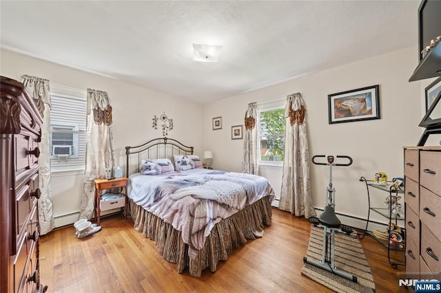 67 6th Ave, Passaic, NJ 07055 - bedroom featuring wood finished floors and a baseboard heating unit