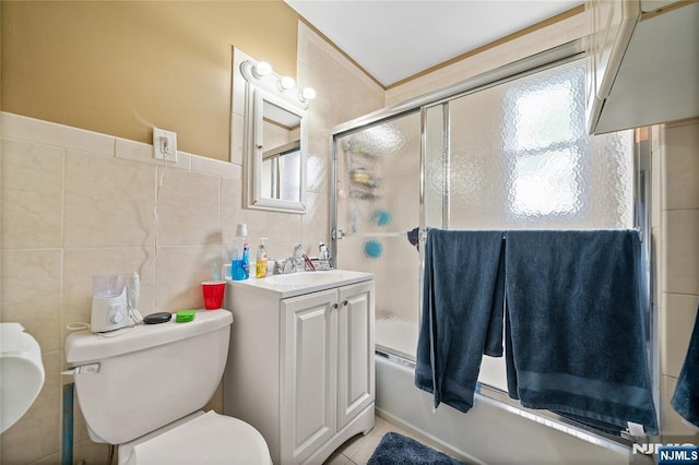 67 6th Ave, Passaic, NJ 07055 - bathroom featuring tile walls, vanity, combined bath / shower with glass door, and tile patterned flooring