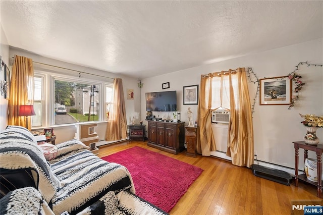 67 6th Ave, Passaic, NJ 07055 - living area featuring wood-type flooring and a textured ceiling