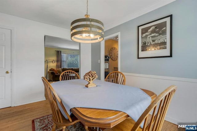 116 Springfield Ave, Hasbrouck Heights, NJ 07604 - dining room with wood finished floors, a chandelier, and crown molding