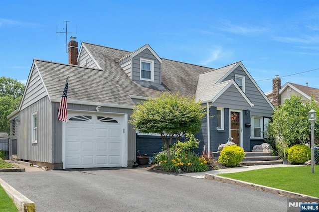 116 Springfield Ave, Hasbrouck Heights, NJ 07604 - cape cod house featuring a shingled roof, a chimney, driveway, and a front yard