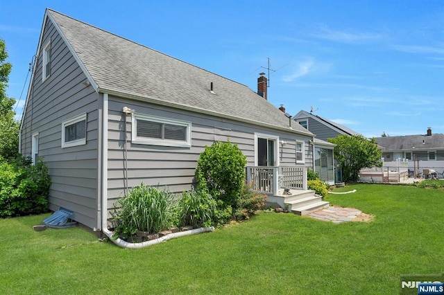 116 Springfield Ave, Hasbrouck Heights, NJ 07604 - rear view of property with a yard, a shingled roof, and a chimney