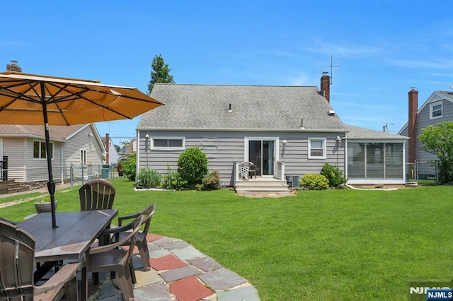 116 Springfield Ave, Hasbrouck Heights, NJ 07604 - back of house featuring a chimney, a sunroom, outdoor dining area, roof with shingles, and a patio area