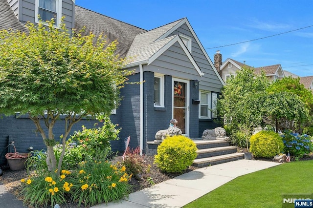 116 Springfield Ave, Hasbrouck Heights, NJ 07604 - view of front facade featuring a front lawn, brick siding, and a shingled roof
