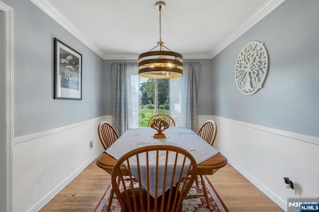 116 Springfield Ave, Hasbrouck Heights, NJ 07604 - dining space featuring ornamental molding, light wood finished floors, and a wainscoted wall
