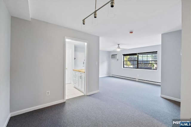 412-432 Broadway Unit 25A, Passaic, NJ 07055 - carpeted empty room with baseboard heating, a ceiling fan, a wall mounted AC, and rail lighting