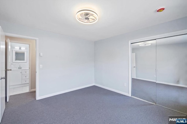 412-432 Broadway Unit 25A, Passaic, NJ 07055 - unfurnished bedroom featuring dark colored carpet and a closet