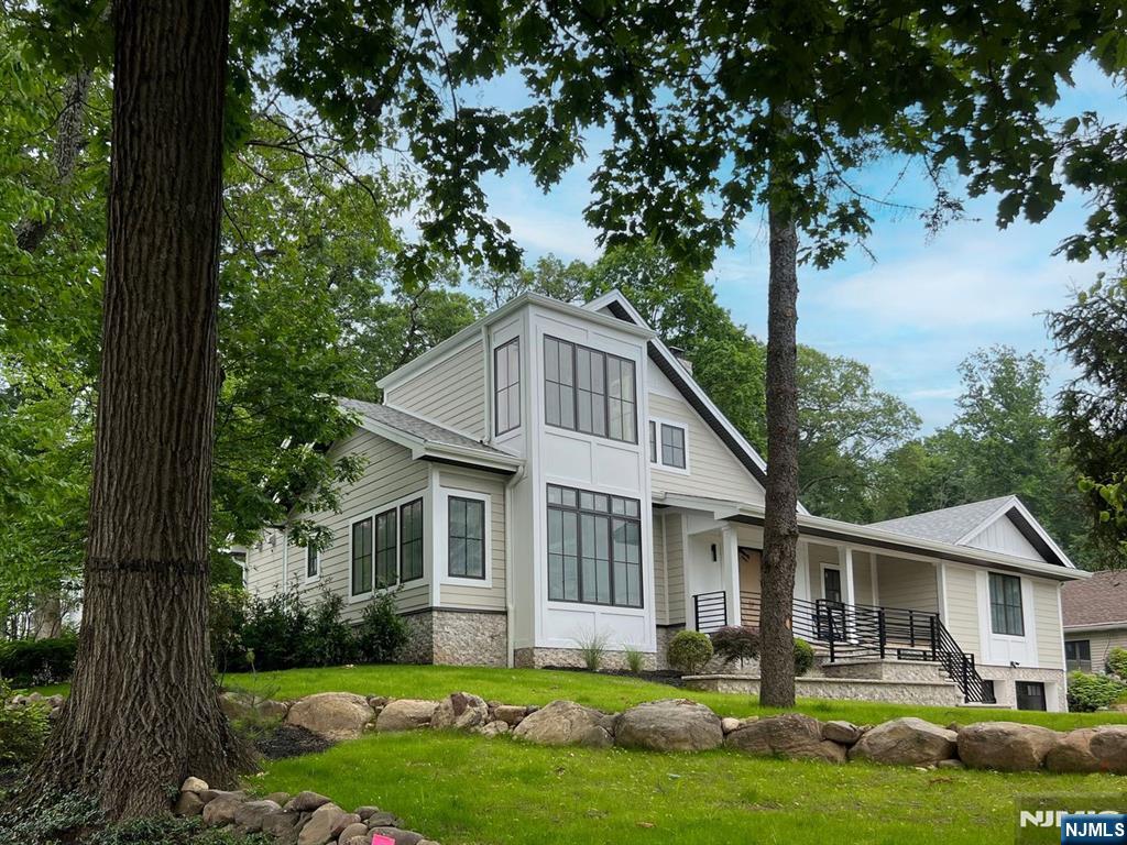 205 Pines Lake Dr, Wayne, NJ 07470 - view of front of property featuring covered porch and a front lawn