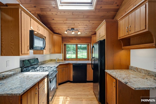 34 Tintle Rd, Kinnelon Borough, NJ 07405 - kitchen featuring black appliances, light wood-style floors, wood ceiling, light stone countertops, and a skylight