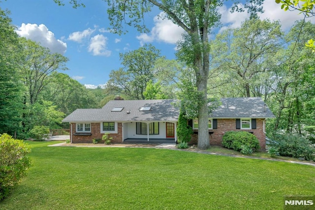 34 Tintle Rd, Kinnelon Borough, NJ 07405 - ranch-style house featuring brick siding, a front lawn, and a chimney