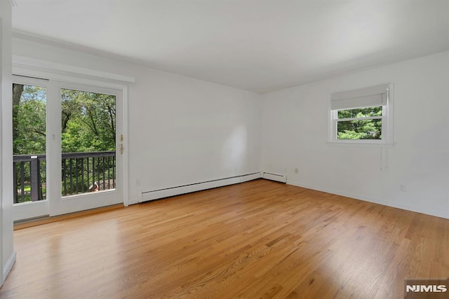 34 Tintle Rd, Kinnelon Borough, NJ 07405 - unfurnished room with baseboard heating, healthy amount of natural light, and wood finished floors