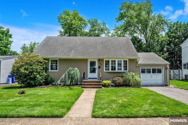 43 Barnert Ave, Totowa, NJ 07512 - cape cod-style house with an attached garage, a front yard, a shingled roof, and driveway