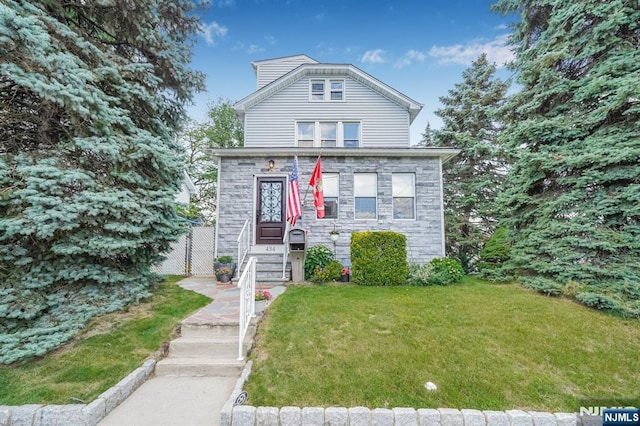 434 3rd Ave, Lyndhurst, NJ 07071 - view of front facade featuring stone siding and a front lawn