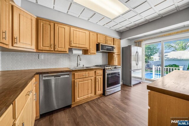 434 3rd Ave, Lyndhurst, NJ 07071 - kitchen featuring appliances with stainless steel finishes, dark wood-style flooring, tasteful backsplash, and dark countertops