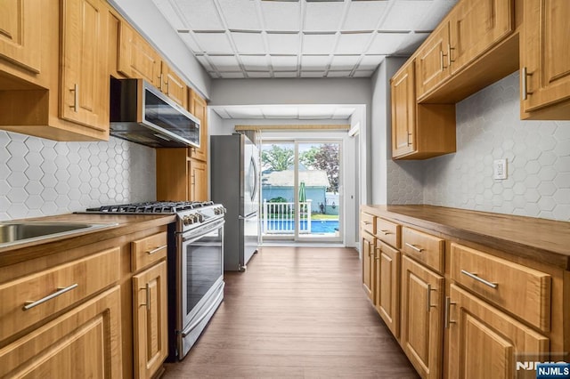 434 3rd Ave, Lyndhurst, NJ 07071 - kitchen featuring stainless steel appliances, butcher block countertops, dark wood-style flooring, and backsplash