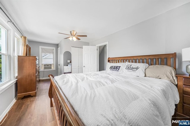 434 3rd Ave, Lyndhurst, NJ 07071 - bedroom featuring wood finished floors, cooling unit, a ceiling fan, a closet, and arched walkways