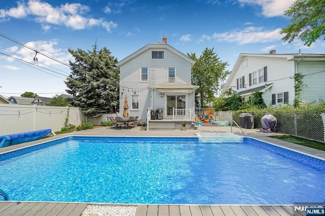 434 3rd Ave, Lyndhurst, NJ 07071 - view of swimming pool featuring a deck, a fenced backyard, and a patio area
