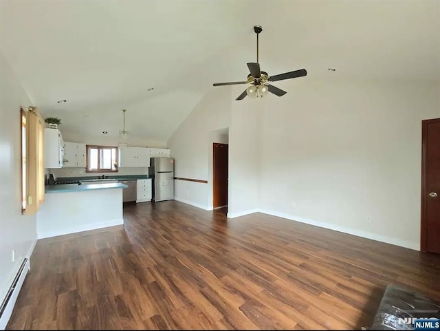 137 Prospect St, Lodi, NJ 07644 - unfurnished living room with baseboard heating, dark wood-type flooring, a ceiling fan, and vaulted ceiling