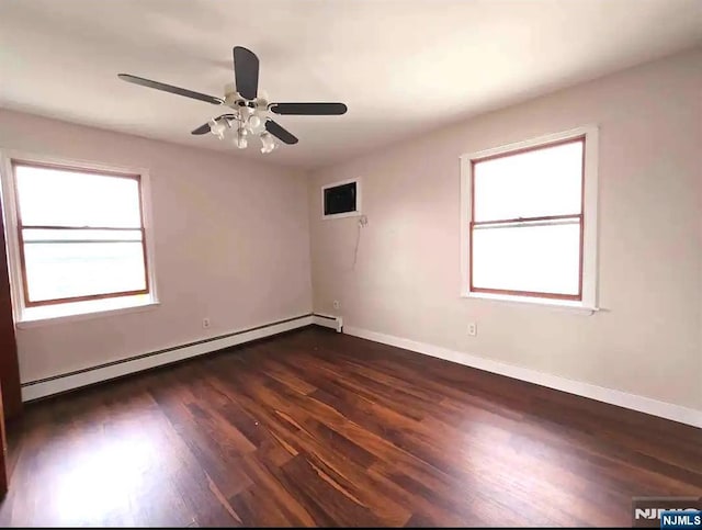 137 Prospect St, Lodi, NJ 07644 - spare room with baseboard heating, dark wood-style flooring, and a ceiling fan