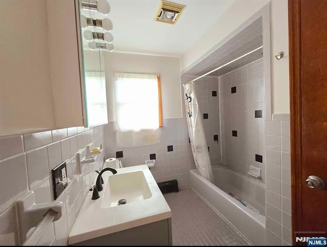137 Prospect St, Lodi, NJ 07644 - full bath with tile walls, vanity, shower / tub combo with curtain, a wainscoted wall, and tile patterned flooring