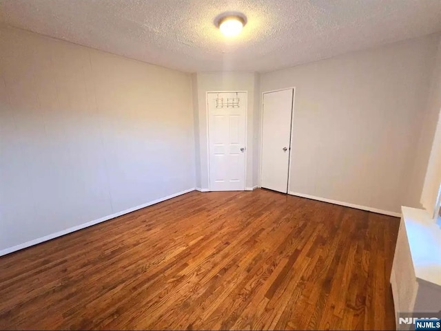 137 Prospect St, Lodi, NJ 07644 - empty room featuring a textured ceiling and wood finished floors