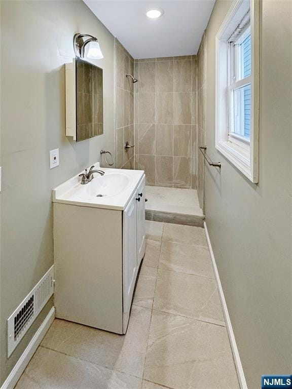 132 Lincoln Ave, Orange, NJ 07050 - full bathroom with a tile shower, vanity, and tile patterned floors