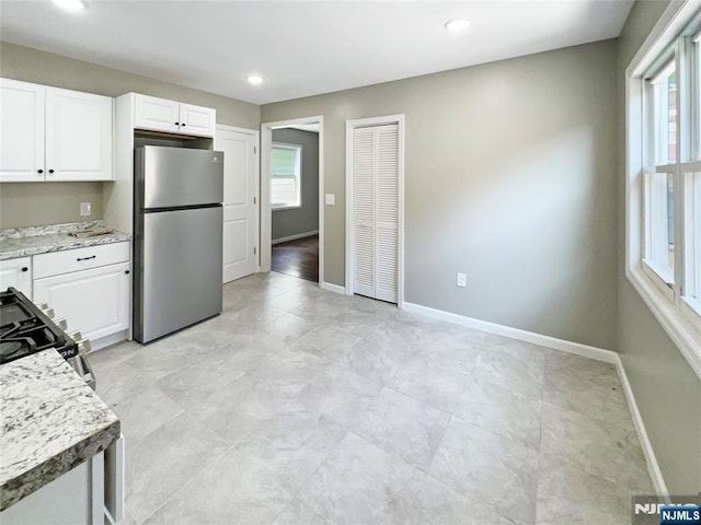 132 Lincoln Ave, Orange, NJ 07050 - kitchen featuring freestanding refrigerator, gas range, plenty of natural light, white cabinets, and recessed lighting