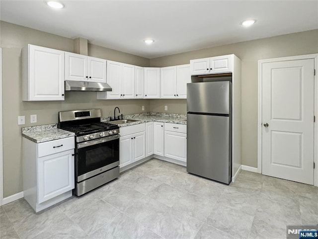 132 Lincoln Ave, Orange, NJ 07050 - kitchen featuring stainless steel appliances, under cabinet range hood, white cabinetry, light stone counters, and recessed lighting