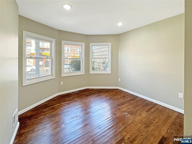 132 Lincoln Ave, Orange, NJ 07050 - empty room featuring dark wood-style floors and recessed lighting