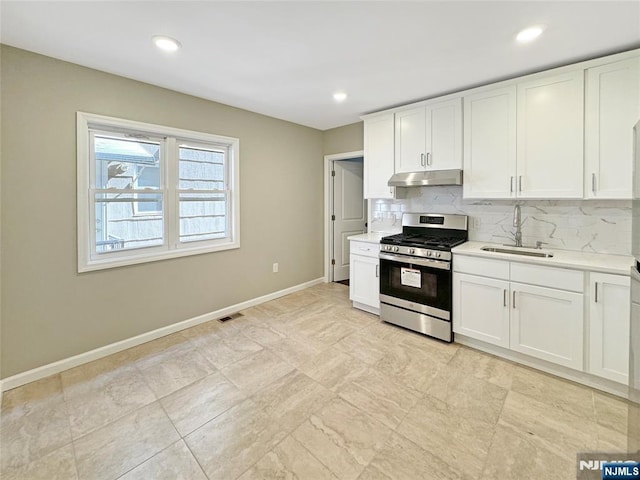 132 Lincoln Ave, Orange, NJ 07050 - kitchen featuring stainless steel gas range, under cabinet range hood, light countertops, decorative backsplash, and recessed lighting