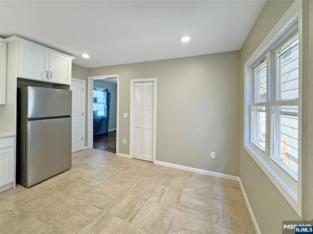 132 Lincoln Ave, Orange, NJ 07050 - kitchen with freestanding refrigerator, white cabinets, light countertops, and recessed lighting