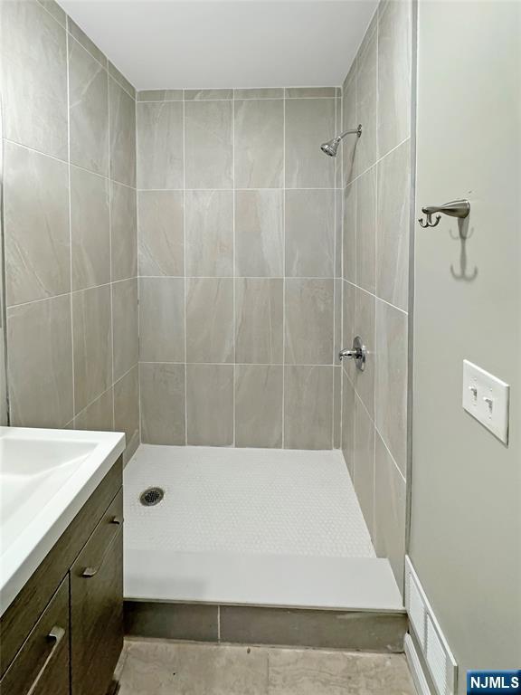 132 Lincoln Ave, Orange, NJ 07050 - full bathroom featuring tiled shower and vanity