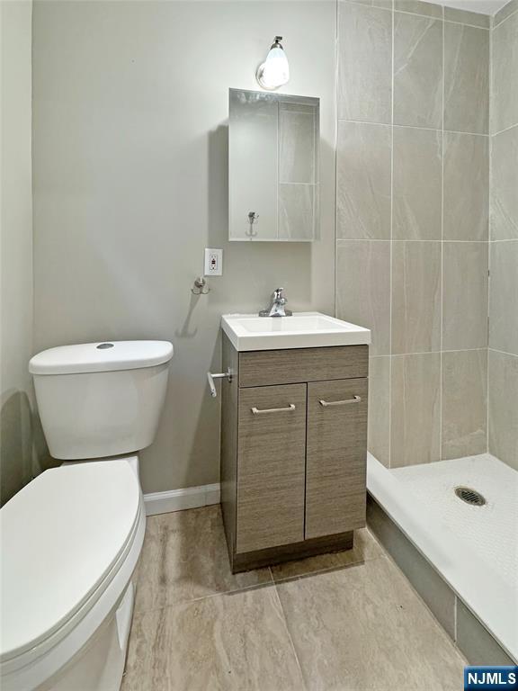 132 Lincoln Ave, Orange, NJ 07050 - bathroom featuring vanity and a tile shower