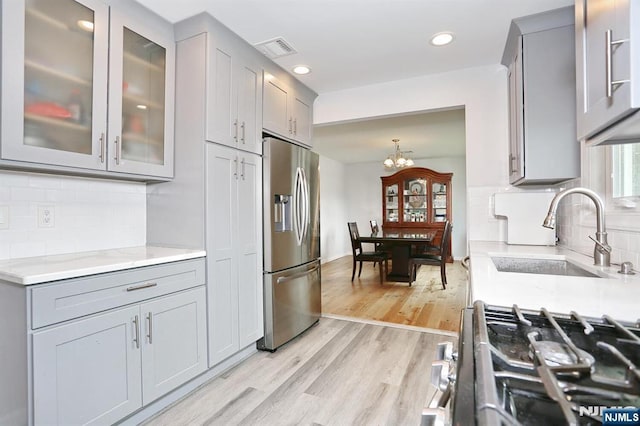 8 Cedar Rd, Dumont, NJ 07628 - kitchen with stainless steel appliances, gray cabinets, light wood-style floors, tasteful backsplash, and recessed lighting