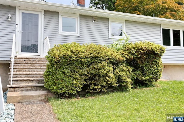 8 Cedar Rd, Dumont, NJ 07628 - doorway to property with a chimney and a yard