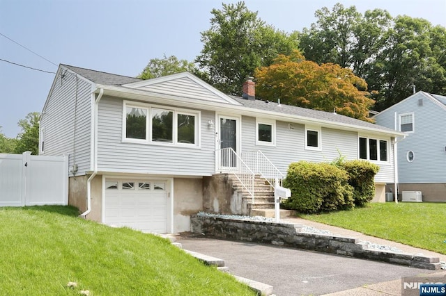 8 Cedar Rd, Dumont, NJ 07628 - view of front of house featuring an attached garage, asphalt driveway, and a chimney