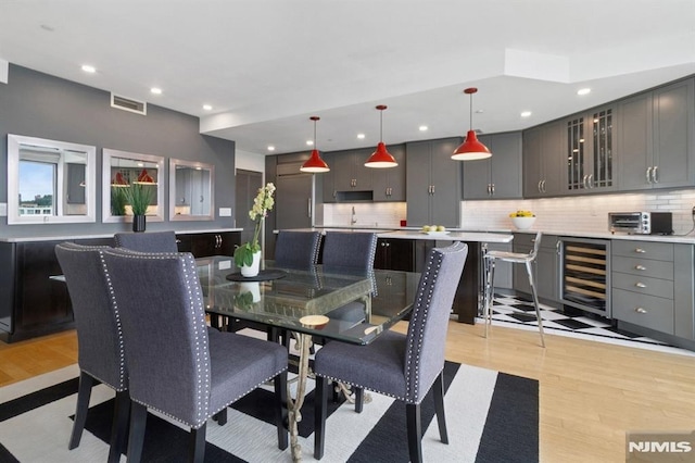 600 Harbor Blvd Unit 973/975, Weehawken, NJ 07086 - dining space featuring wine cooler, light wood finished floors, recessed lighting, and bar