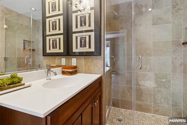 600 Harbor Blvd Unit 973/975, Weehawken, NJ 07086 - bathroom with vanity, tile walls, and a shower stall