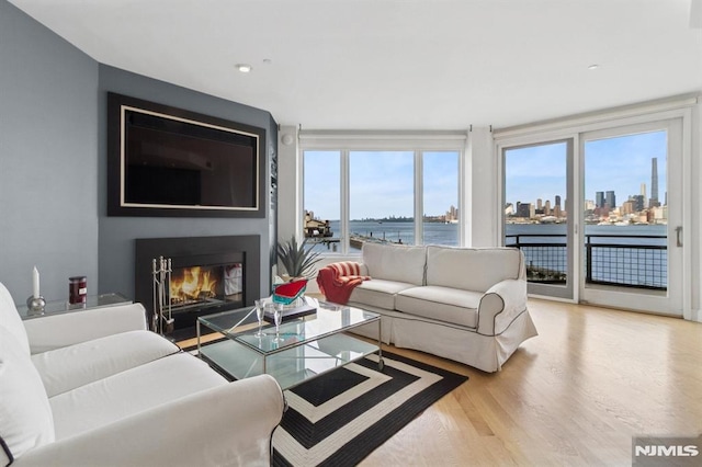 600 Harbor Blvd Unit 973/975, Weehawken, NJ 07086 - living room featuring wood finished floors, a glass covered fireplace, and recessed lighting