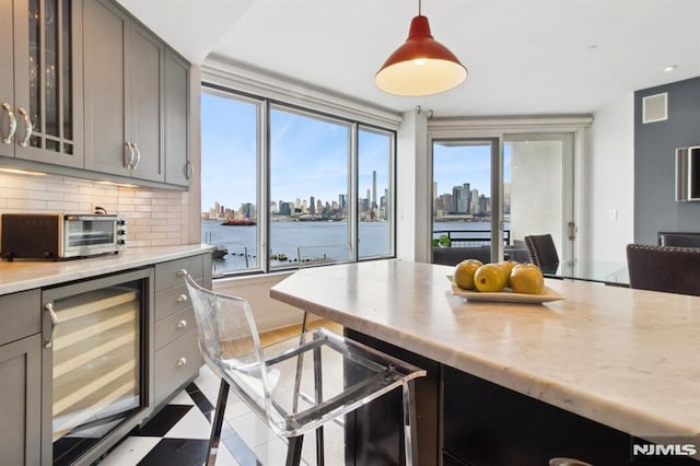 600 Harbor Blvd Unit 973/975, Weehawken, NJ 07086 - kitchen featuring wine cooler, gray cabinetry, a skyline view, and light countertops