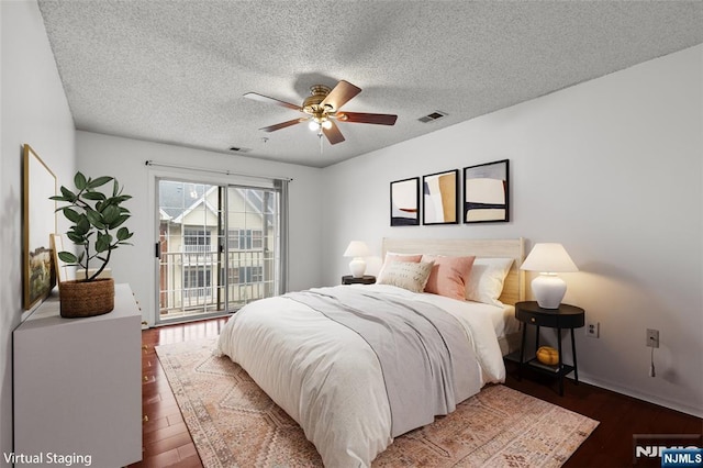 53 Marrow St Unit 2605, Newark, NJ 07103 - bedroom featuring access to outside, wood-type flooring, a textured ceiling, and ceiling fan