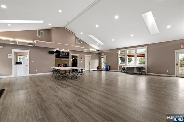 53 Marrow St Unit 2605, Newark, NJ 07103 - misc room with a skylight, high vaulted ceiling, wood finished floors, a stone fireplace, and recessed lighting