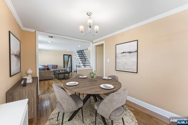 837 Keep St, Linden, NJ 07036 - dining room featuring stairs, wood finished floors, a chandelier, and ornamental molding