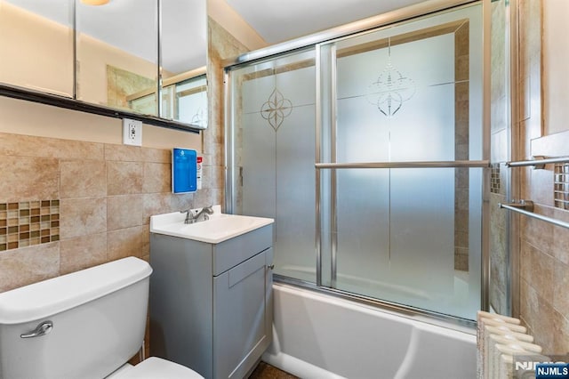837 Keep St, Linden, NJ 07036 - bathroom with shower / bath combination with glass door, vanity, radiator, and tile walls