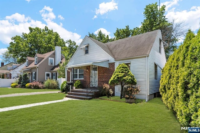 837 Keep St, Linden, NJ 07036 - bungalow featuring a front lawn, roof with shingles, and brick siding