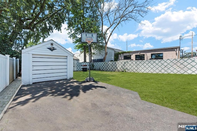 837 Keep St, Linden, NJ 07036 - view of patio featuring driveway, an outdoor structure, and a garage