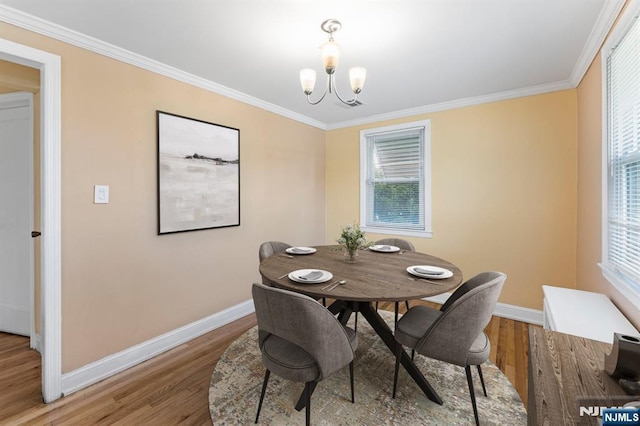 837 Keep St, Linden, NJ 07036 - dining space with light wood-style floors, a chandelier, and ornamental molding