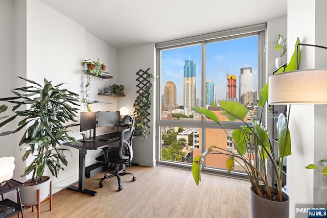 201 Marin Blvd Unit 1209, Jersey City, NJ 07302 - home office with wood finished floors and floor to ceiling windows
