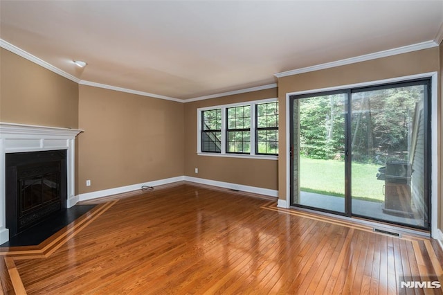 29 Concord Rd Unit F, West Milford, NJ 07480 - unfurnished living room featuring hardwood / wood-style floors, a fireplace with raised hearth, and crown molding
