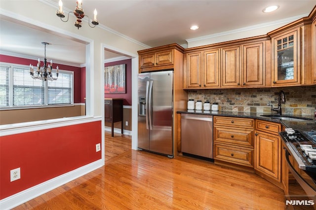 29 Concord Rd Unit F, West Milford, NJ 07480 - kitchen with stainless steel appliances, a chandelier, brown cabinets, light wood finished floors, and crown molding
